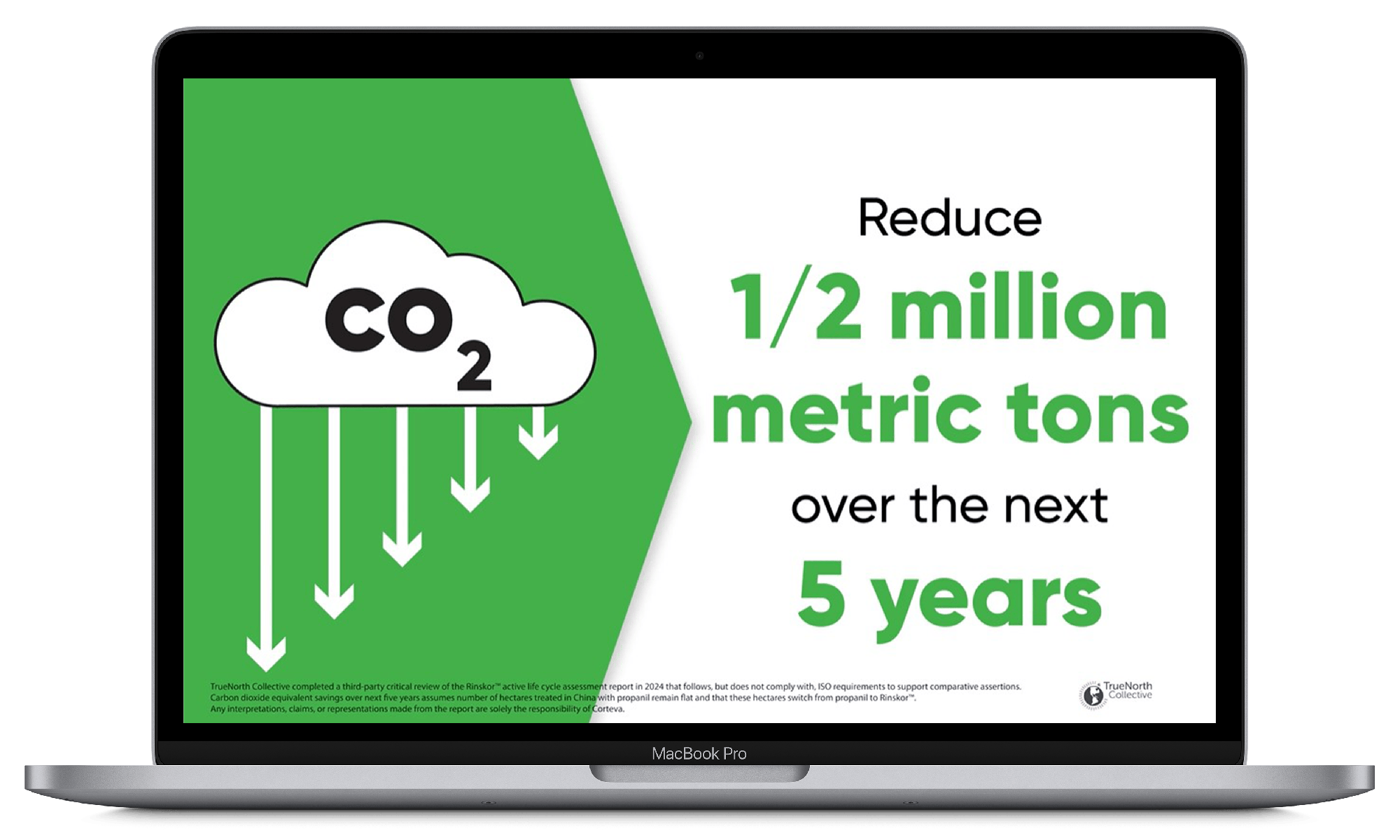 A MacBook Pro displaying a graphic with a cloud labeled CO2 and downward arrows, accompanied by text that reads: 'Reduce 1/2 million metric tons over the next 5 years.